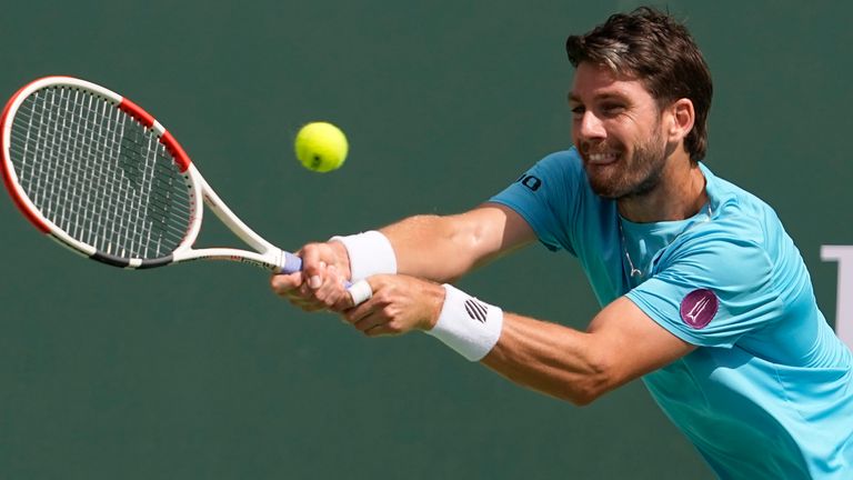 Cameron Norrie, of Britain, returns a shot to Frances Tiafoe, of the United States, at the BNP Paribas Open tennis tournament Wednesday, March 15, 2023, in Indian Wells, Calif. (AP Photo/Mark J. Terrill)