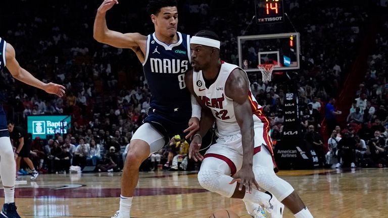 Miami Heat forward Jimmy Butler (22) dribbles around Dallas Mavericks guard Josh Green (8) during the second half of an NBA basketball game Saturday, April 1, 2023, in Miami. (AP Photo/Marta Lavandier)