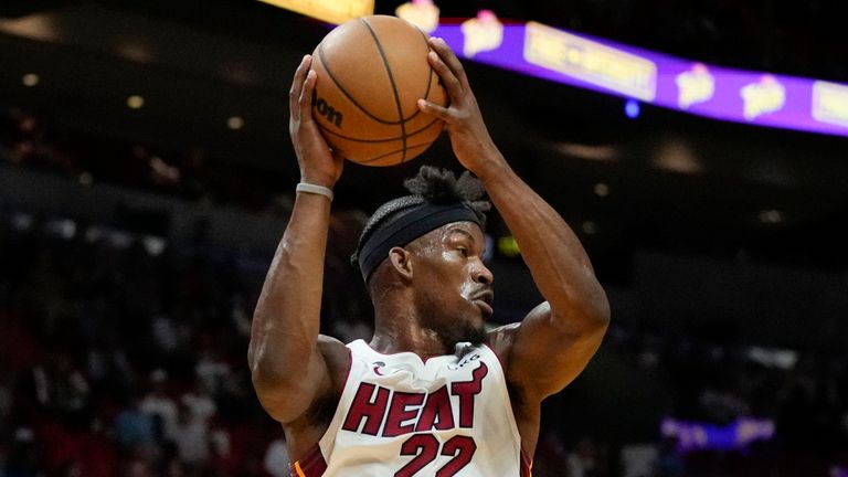 Miami Heat forward Jimmy Butler (22) jumps to pass, while defended by Utah Jazz forward Rudy Gay, center left, during the first half of an NBA basketball game, Monday, March 13, 2023, in Miami. (AP Photo/Rebecca Blackwell)